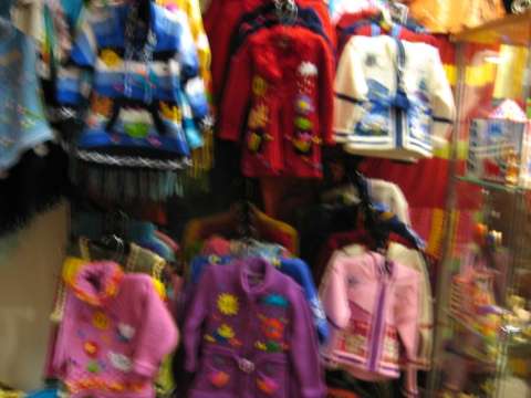 Children's sweaters handmade with the technique of arpilleras with different  applications, colorful and beautiful figures.