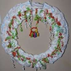 24" UNISEX BABY DIAPER WREATH WITH WRIST RATTLE, SHAKE RING RATTLE, FAVOR BOTTLE & RATTLE