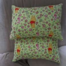 2 winnie the pooh travel sofa pillows .