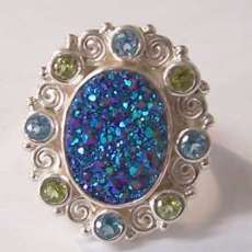 oval druzy ring surrounded with blue topaz and peridot