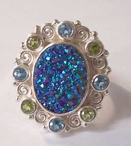 oval druzy ring surrounded with blue topaz and peridot