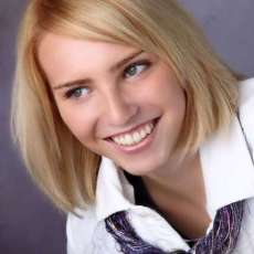 Fiber Necklace worn under white collared jacket is made with 6 different novelty yarn fibers