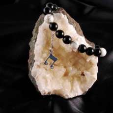 7 1/2 in Onyx & Howlite bracelet with sterling silver charm.