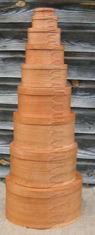 A nine-box stack of Shaker Boxes in natural, quarter-sawn cherry.