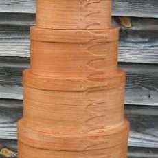 A nine-box stack of Shaker Boxes in natural, quarter-sawn cherry.