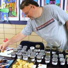 Tilton taking a sample of his jams