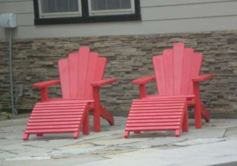 Tom's Adirondack chairs in red with foot rests