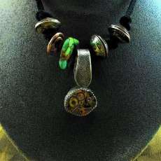 Steampunk necklace, with Mojave green, sterling silver a seventeen jeweled movement.