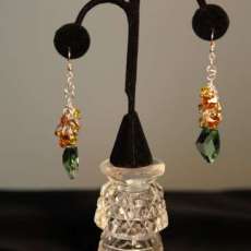 Genuine Swarovski Crystal peridot color dangle sterling silver earrings.