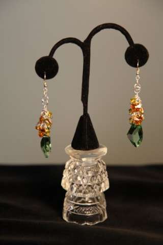 Genuine Swarovski Crystal peridot color dangle sterling silver earrings.