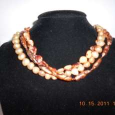Triple strand shell and pearl W/swarovoki crystal spacers with a sterling silver clasp 18 inches long
