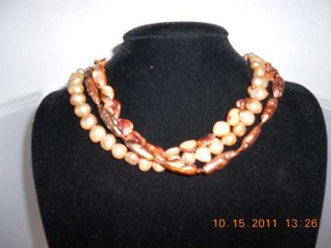 Triple strand shell and pearl W/swarovoki crystal spacers with a sterling silver clasp 18 inches long