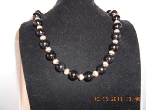 Onyx with sterling silver spacers with a sterling silver clasp 24 inches long