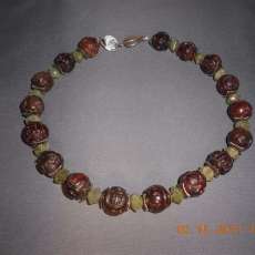 Carved stone w/ green stone and silver spacers with a beautiful leaf shaped  sterling silver clasp 17 inches