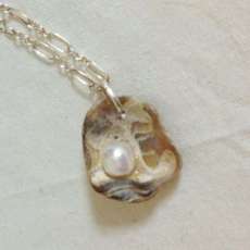 Oyster fossil and pearl necklace