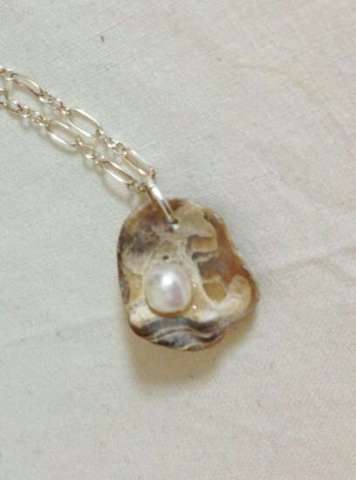Oyster fossil and pearl necklace