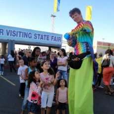 stilt walking and balloon twisting at a state fair