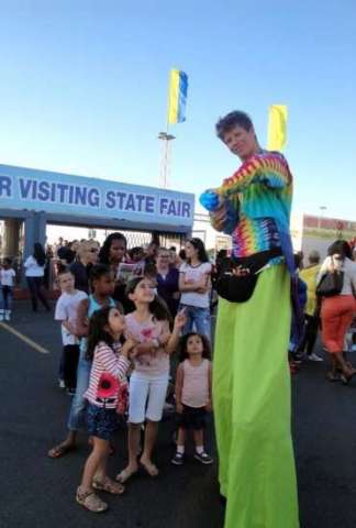 stilt walking and balloon twisting at a state fair