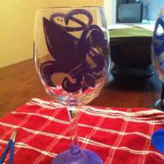 hand painted wine glass with initial and fleur de lis