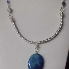Hand Twisted silver metal necklace with blue crystals and large blue stone