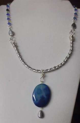 Hand Twisted silver metal necklace with blue crystals and large blue stone