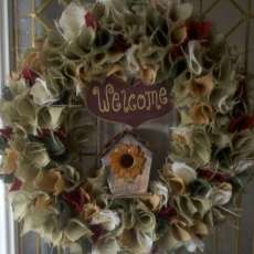 Multi colored burlap wreath with bird house and welcome sign