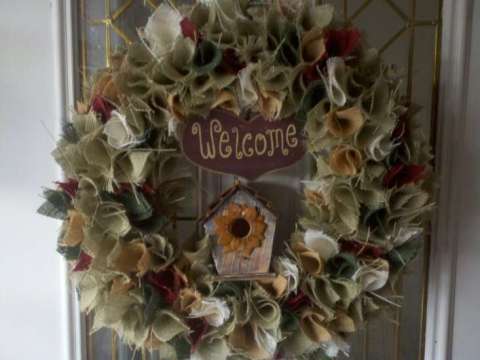 Multi colored burlap wreath with bird house and welcome sign