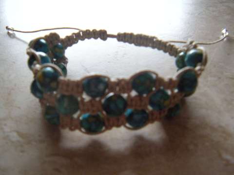 Light Blue crystal beads and beige wax cord triple bracelet. Adjustable from 6.5 to 10 in. wrists. $20.00usd