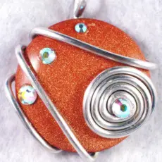Goldstone pendant with AB Swarovski crystals wire wrapped