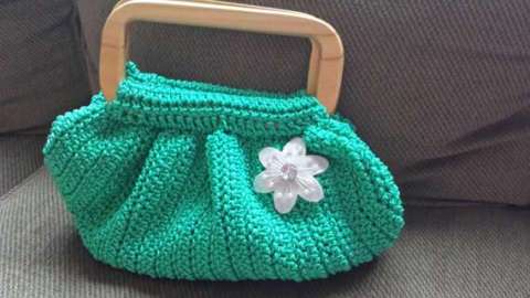 Wooden handle crocheted handbag