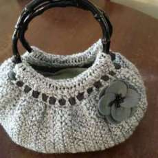 Very cute, grey crocheted handbag.