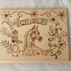 Woodburned welcome sign