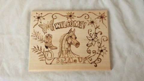 Woodburned welcome sign