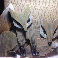 Foxes cut from repurpose weathered fence