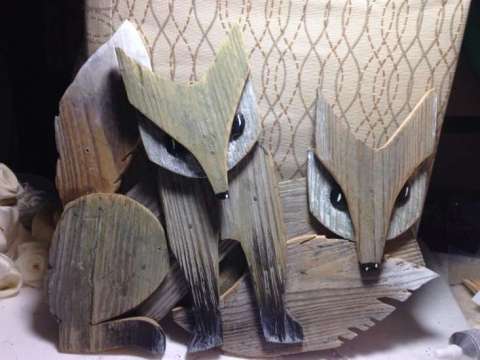 Foxes cut from repurpose weathered fence