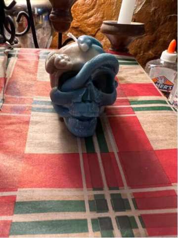 A Candle Shaped Like a Skull With a Snake Coming Out of It All Handmade