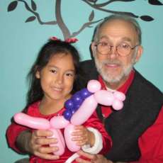 Jon Sundell With Birthday Child and Her Balloon Horse