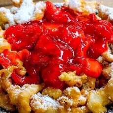 Funnel Cake Covered With Cherries and Powdered Sugar