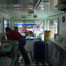 Teal countertops and black and white checkerboard floor