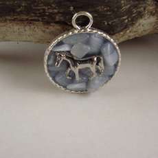 round silver pendant with silver horse