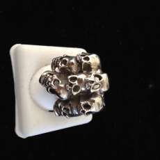 Sterling Silver Hand Made 7 skulls on a ring size 9 3/4.