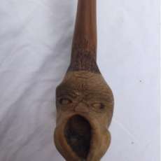 Tobacco pipe with carved face