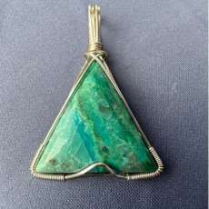 Triangle shaped Chrysocolla pendant wrapped in silver colored wire