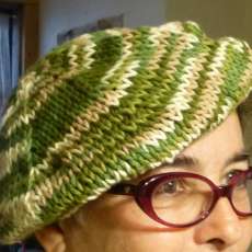 Hand knit cotton tam in variegated greens and white