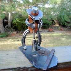 Horseshoe cowboy sculpture digging posthole.